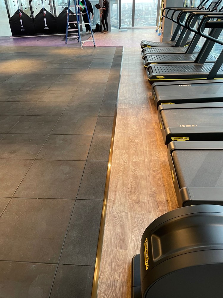 Gym flooring with inlaid timber and LED detail